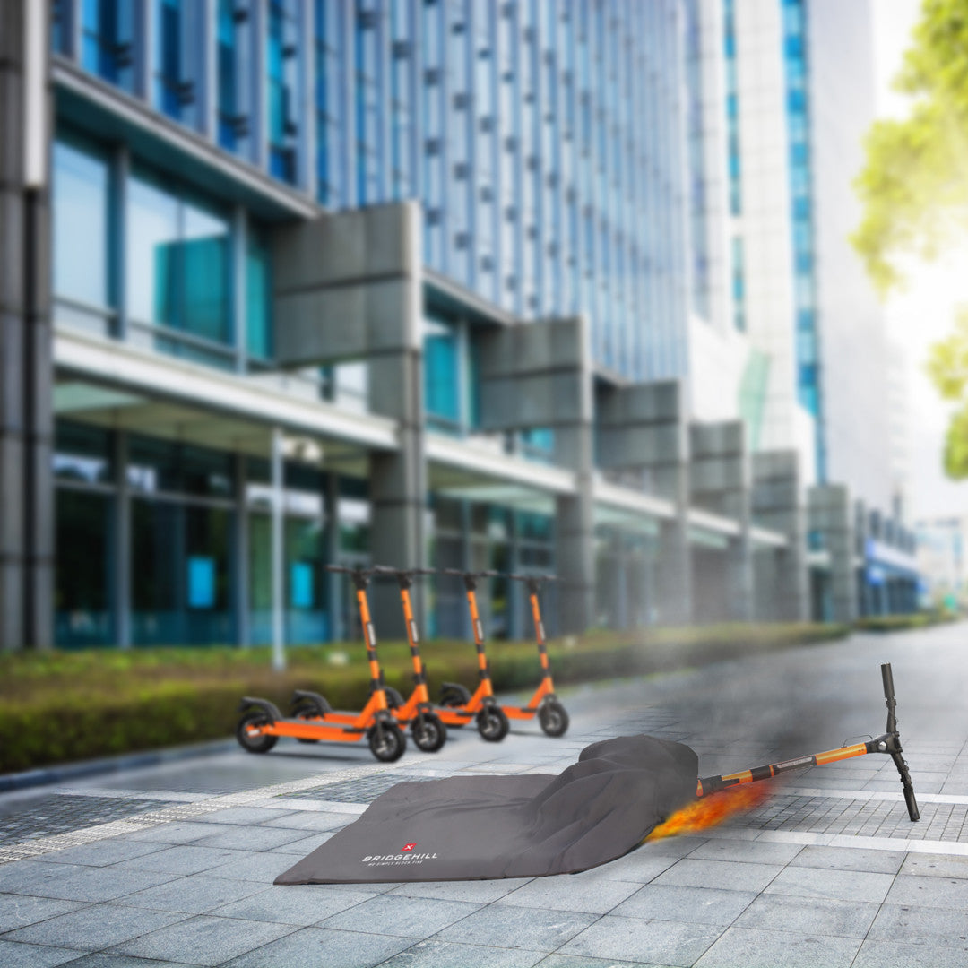 Couverture anti-feu Bridgehill Lithium sur une trottinette électrique en feu